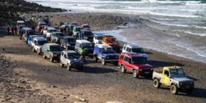 large group of 4x4 vehicles on the beach.
